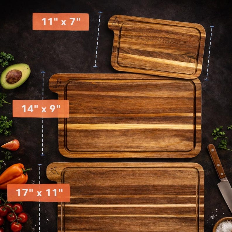 May include: Three wooden cutting boards of varying sizes. The largest is 17" x 11", the middle one is 14" x 9", and the smallest is 11" x 7". Each board has a juice groove and a handle. The wood grain is visible.