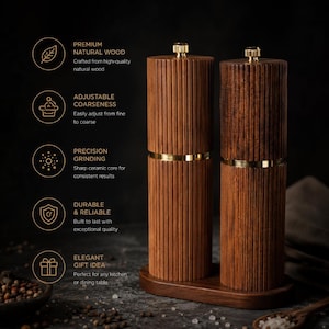 May include: Two wooden salt and pepper grinders with a ribbed design, gold accents, and a wooden base. The grinders are made of natural wood and are designed for adjustable coarseness and precision grinding. The image also includes text that says "Premium Natural Wood", "Adjustable Coarseness", "Precision Grinding", "Durable & Reliable", and "Elegant Gift Idea".