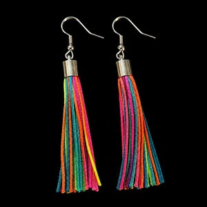 May include: A pair of drop earrings featuring long, multi-coloured thread tassels in vibrant shades of neon pink, orange, yellow, green, and blue. Each tassel is secured with a silver-toned metal cap and attached to a silver-toned hook wire.