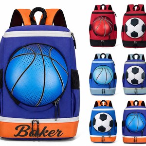 May include: A collection of sports-themed backpacks in various colors. The primary backpack is blue with a large basketball graphic, orange accents, and the name "Baker" in orange. Other backpacks feature basketballs and soccer balls.