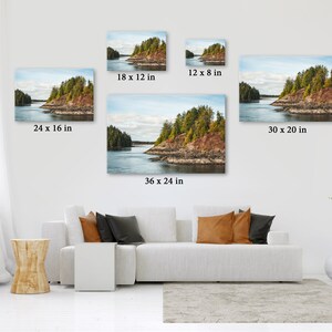 May include: A collection of landscape canvas prints in various sizes, including 24 x 16 inches, 18 x 12 inches, 12 x 8 inches, 36 x 24 inches, and 30 x 20 inches. The prints depict a scenic view of a coastal island with lush green trees and a calm body of water.