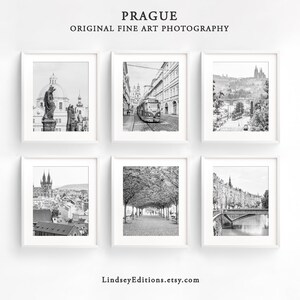 May include: A set of six black and white photographs of Prague, Czech Republic. The photos feature various landmarks, including a statue, a tram, a bridge, and a church.