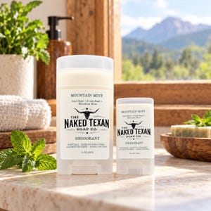 May include: Two white deodorant sticks by The Naked Texan Soap Co. in Mountain Mint scent. The larger stick is 3 oz and the smaller is .55 oz. Labels feature a bull skull logo and text: Cool Mint, Fresh Basil, Mountain Moss, Natural, Baking Soda Free, Aluminum Free, Odor Control.