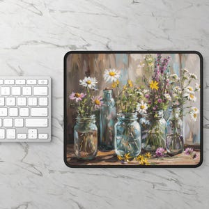 May include: Mousepad featuring a still life of wildflowers in glass jars and bottles. The flowers include daisies, purple, and yellow blooms. The background is a wooden panel. A white keyboard is in the background.