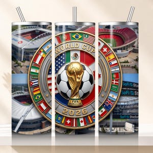 May include: A stainless steel tumbler featuring a FIFA World Cup 2026 design. The design includes a soccer ball, the World Cup trophy, and flags of participating nations. Stadium images are also visible.