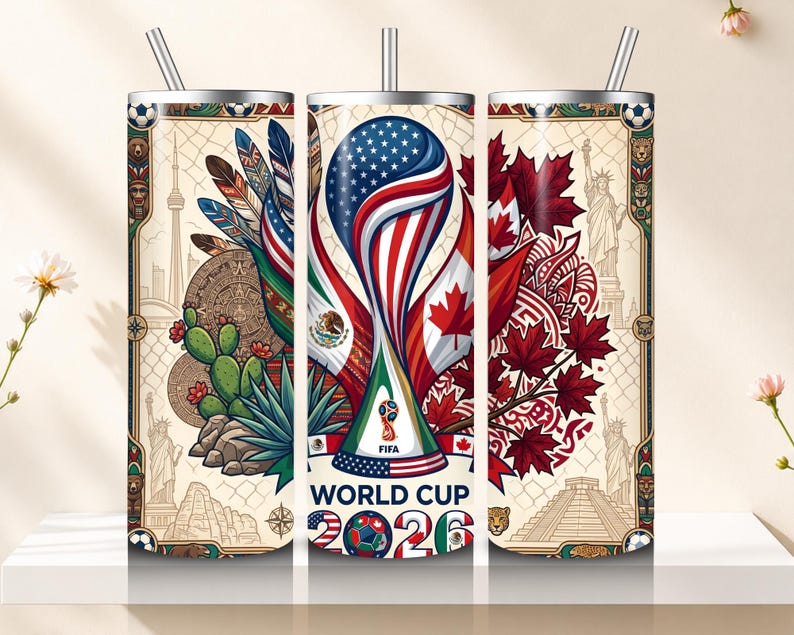May include: A stainless steel tumbler with a straw, featuring a design for the FIFA World Cup 2026. The design incorporates flags of the USA, Mexico, and Canada, along with iconic landmarks and soccer ball graphics. The text "WORLD CUP 2026" is prominently displayed.