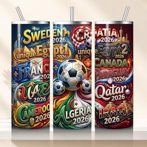 May include: Three stainless steel insulated tumblers with straws. Each tumbler features a colorful design with country flags, soccer balls, and the text "2026". The tumblers are decorated with the flags of Sweden, France, UAE, Cameroon, Croatia, Canada, Paraguay, Qatar, Algeria, and Iraq.