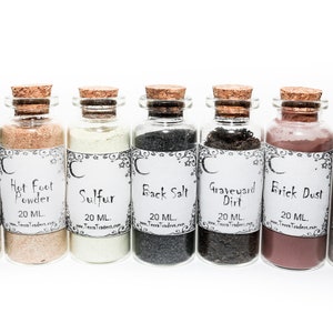 May include: Seven small glass bottles with cork stoppers, each filled with a different type of powder or dirt. The bottles are labeled with the names of the contents: Mullein, Hot Foot Powder, Sulfur, Black Salt, Graveyard Dirt, Brick Dust, and Goofer Dust. Each bottle contains 20 ml of product.