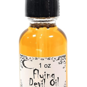 May include: A 1 oz amber glass bottle with a black dropper top. The bottle is filled with a golden liquid and has a white label that reads "1 oz Flying Devil Oil TerraTraders".
