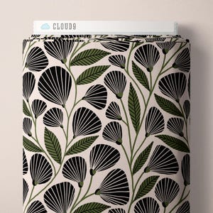 May include: A bolt of fabric featuring a repeating pattern of black fan-shaped flowers and olive green leaves on a light cream background. The top edge of the fabric roll displays a white label with the text CLOUD9 in black lettering.