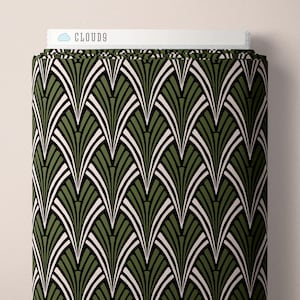 May include: A bolt of fabric featuring a repeating fan-shaped pattern in olive green, black, and off-white. The top edge of the fabric roll displays a white label with a blue cloud icon and the text CLOUD9 printed in black capital letters.