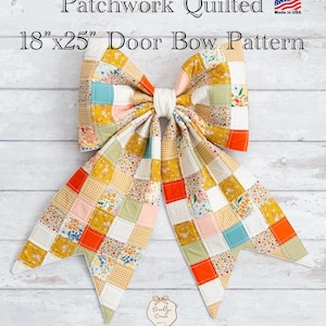 May include: A patchwork quilted door bow pattern measuring 18 inches by 25 inches. The bow features a variety of fabric squares in mustard yellow, orange, teal, pink, and white, with floral and gingham prints. A central white fabric knot holds the bow.