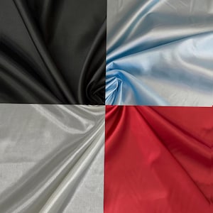 May include: A collage of four fabric swatches featuring a smooth, reflective satin finish. The colors displayed are solid black, light blue, silver-white, and vibrant red. Each section shows the material draped with soft folds and subtle highlights.