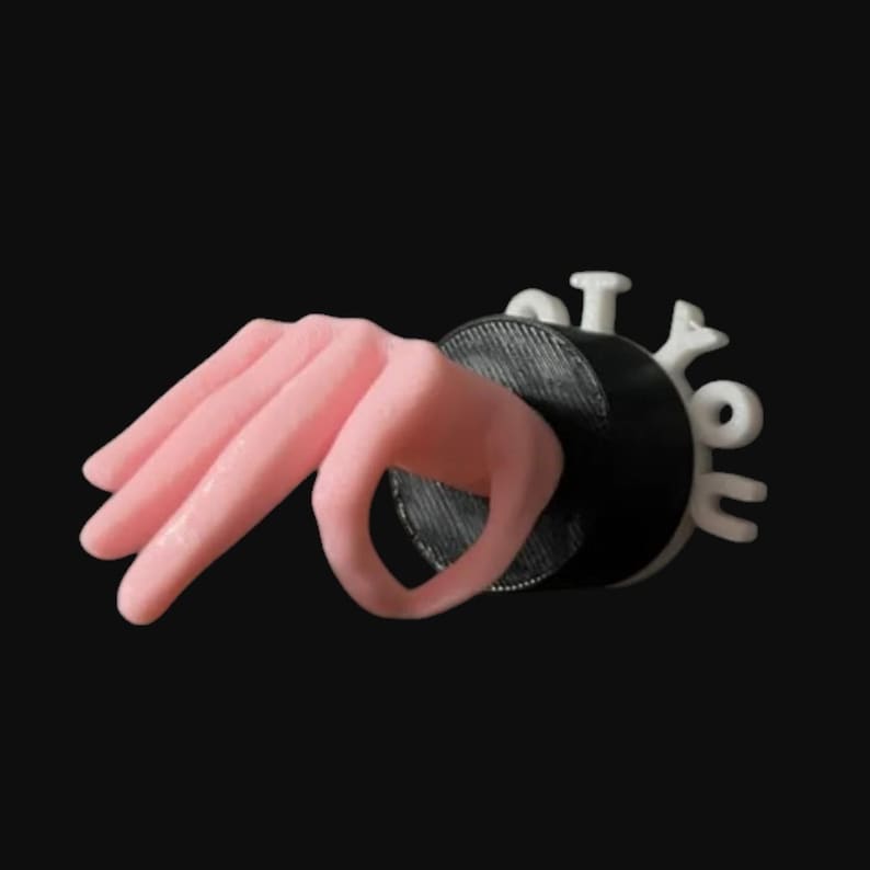 May include: A pink hand emerging from a black circular object, with the white text "I Got You" attached. The hand is in a gesture, with the thumb and index finger forming a circle. The background is black.