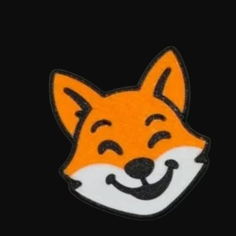 May include: A smiling fox face patch with orange fur, black accents, and a white muzzle. The fox has a happy expression, with a black outline and a black background.