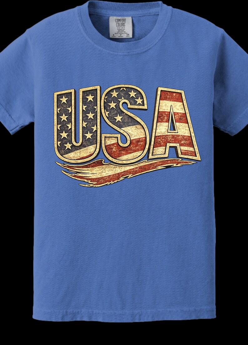 May include: Blue t-shirt with the word "USA" in a distressed, patriotic design. The letters are filled with the American flag's stars and stripes. The shirt is made of a soft material and has a classic crew neck.