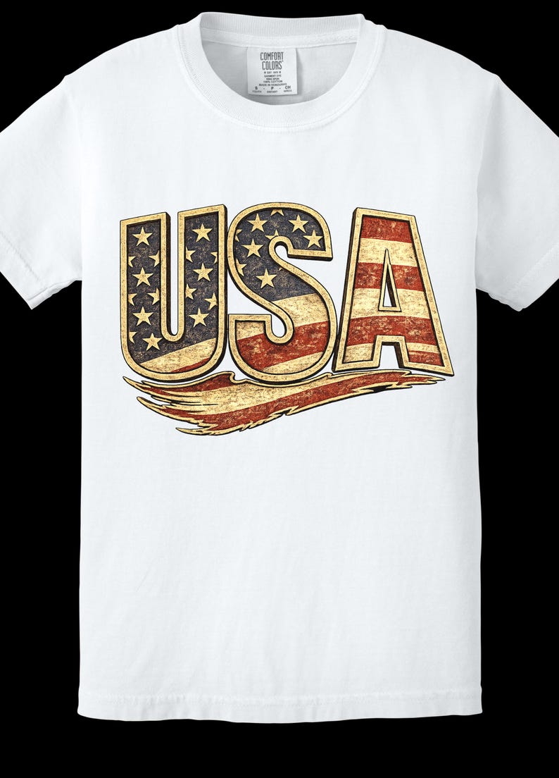 May include: White t-shirt with a distressed "USA" graphic. The letters are designed with the American flag, featuring stars and stripes. The shirt has a crew neck and short sleeves, made of a soft material.