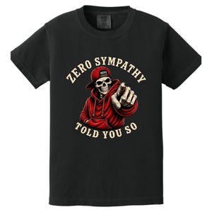 May include: Black t-shirt featuring a skeleton wearing a red hoodie and a baseball cap with the word "Nope". The skeleton is pointing with its index finger. The text "ZERO SYMPATHY TOLD YOU SO" is printed around the skeleton.