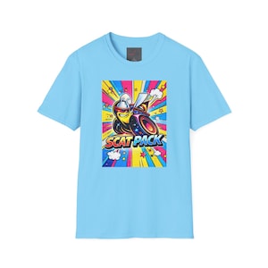 May include: Light blue t-shirt featuring a colorful graphic of a cartoon car with sunglasses and the text "SCAT PACK". The graphic has a retro comic book style with bright colors and starbursts.