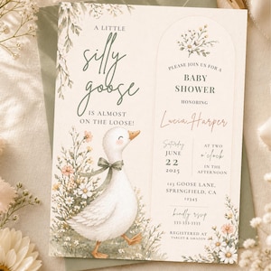May include: Baby shower invitation with a whimsical design. Features a watercolor illustration of a white goose with a green bow, surrounded by flowers. Text reads "A Little Silly Goose is Almost on the Loose!" and baby shower details.