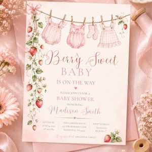 May include: A pink baby shower invitation with the text "Berry Sweet Baby." The invitation features illustrations of baby clothes hanging on a clothesline, strawberries, and floral accents. The invitation is for Madison Smith.