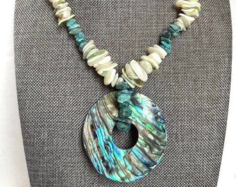 Abalone pendant on light green puka shell necklace with turquoise chips summer beach cruise fashion for women