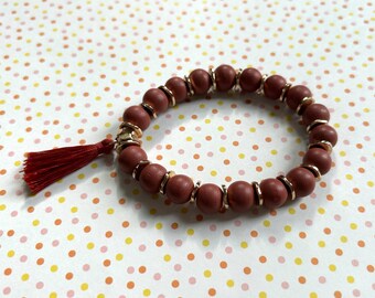 Rust Tassel Bracelet: Goldtone Beads, Stretchable Mala Style