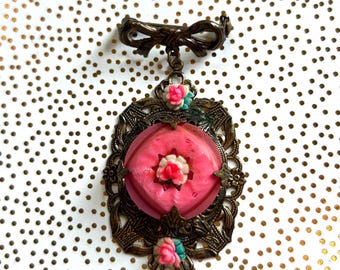 Hanging brooch pin Victorian design with filigree and roses on medallion and bow