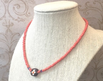 Coral choker necklace with handmade lamp work glass bead embellished daisy flower 1970s style