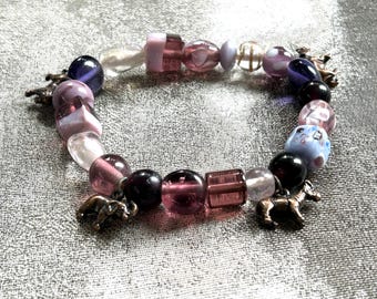 Glass beaded bracelet with zoo animal charms multi colors of purple