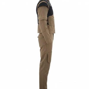 May include: A tan long-sleeve jumpsuit featuring a black vest overlay on the upper torso. The garment includes a high collar, long sleeves, and long trousers with a visible side pocket on the thigh. The vest section has side buckle closures.