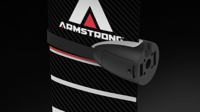 May include: A black and white carbon fiber hydrofoil component with the word "ARMSTRONG" in white text. A black strap with red and white accents secures a black and gray component to the hydrofoil.