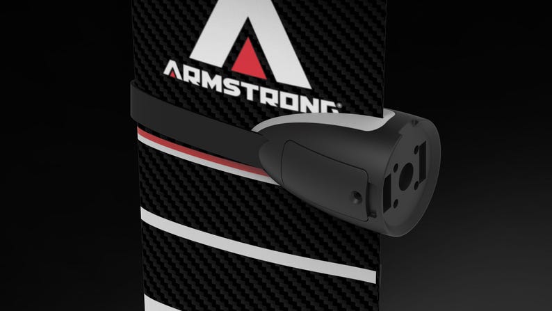 May include: A black and white product with the word "ARMSTRONG" in white text. The product has a black strap with red and white accents. A black and gray component is attached to the strap.
