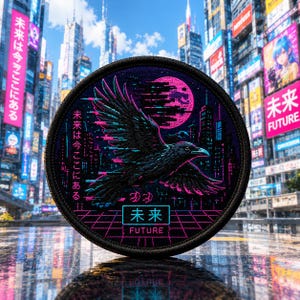 May include: A circular embroidered patch featuring a black crow in flight against a neon pink moon and a dark cityscape. The design includes a pink grid pattern at the bottom, Japanese text, and the English word FUTURE in a cyan rectangular frame.