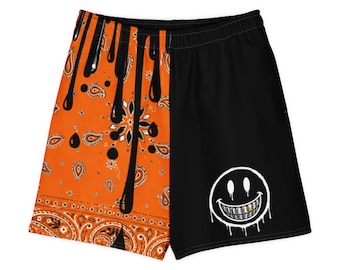 Pantaloncini streetwear arancione e nero con bandana e faccina sorridente, vestibilità unisex estiva a blocchi di colore.