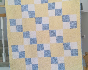 50" X 65" Yellow,  Blue & White Floral and Ribbons Print Quilt. Minky back.