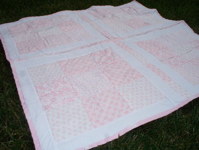 38 x 38 Baby Quilt with Light Pink and White Floral Prints White on White Floral Back and Pink Trim.