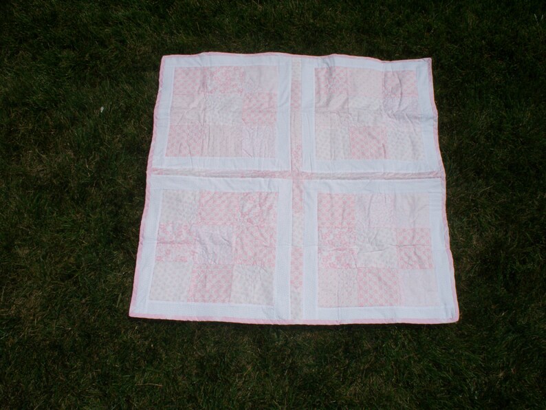 38 x 38 Baby Quilt with Light Pink and White Floral Prints White on White Floral Back and Pink Trim.