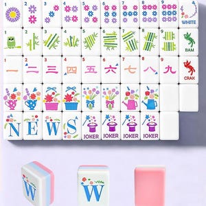 May include: A set of white Mahjong tiles featuring colorful illustrations of flowers, bamboo, owls, and magic hats. The tiles display numbers one through nine in various styles, the word WHITE, the word BAM, the word CRAK, and the word NEWS.