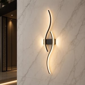 May include: Contemporary wall light featuring a black metal frame with a fluid, curved design. The light emits a warm glow, creating a stylish and modern atmosphere. The fixture is mounted on a marble-effect wall.