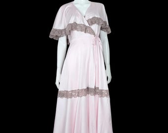 May include: A pale pink wrap-style floor-length robe featuring short flutter sleeves and a V-neckline. The garment is accented with wide, dark taupe lace trim along the neckline, sleeves, mid-skirt, and hemline, with a side tie closure.