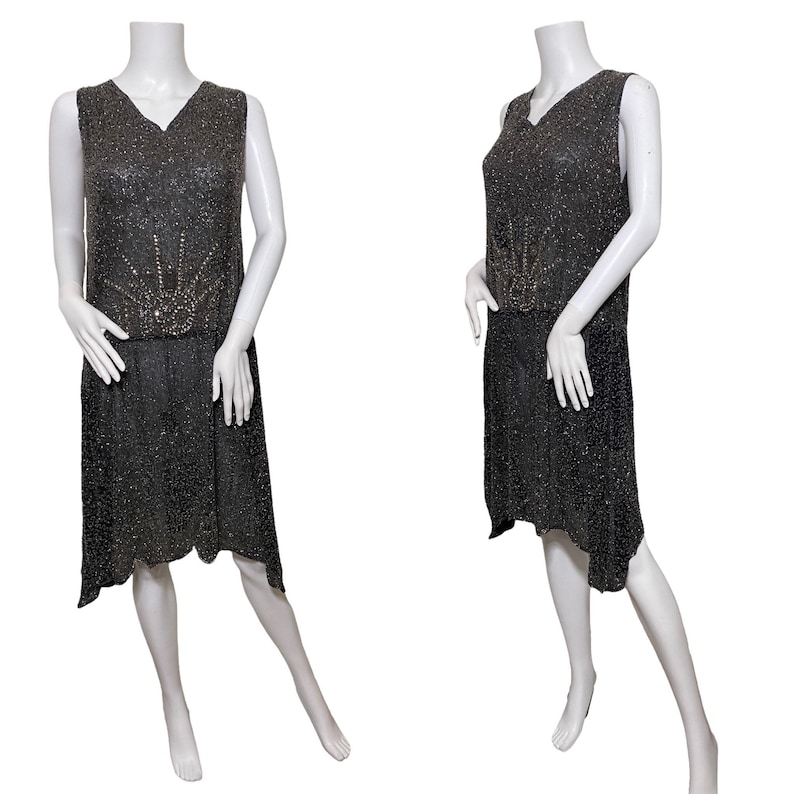 May include: A sleeveless black beaded flapper dress with a geometric design of silver beads on the bodice.