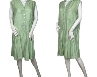 May include: A sleeveless, light green dress with a button-up front and a gathered skirt. The dress is made of a lightweight fabric and has a relaxed fit.