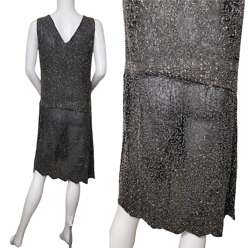 May include: A sleeveless, knee-length dress made of silver and black beads. The dress has a V-neckline and a loose, flowing silhouette.