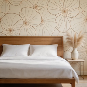 May include: A wooden bed frame with white bedding and pillows. A vase with dried pampas grass sits on a small side table. The wall behind the bed features a large floral pattern in shades of beige and brown.