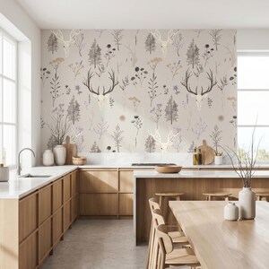 May include: A wallpaper featuring a repeating pattern of deer skulls with antlers, pine trees, and various wildflowers in muted tones of brown, beige, and soft purple on a light beige background, applied to a kitchen wall above wooden cabinets.