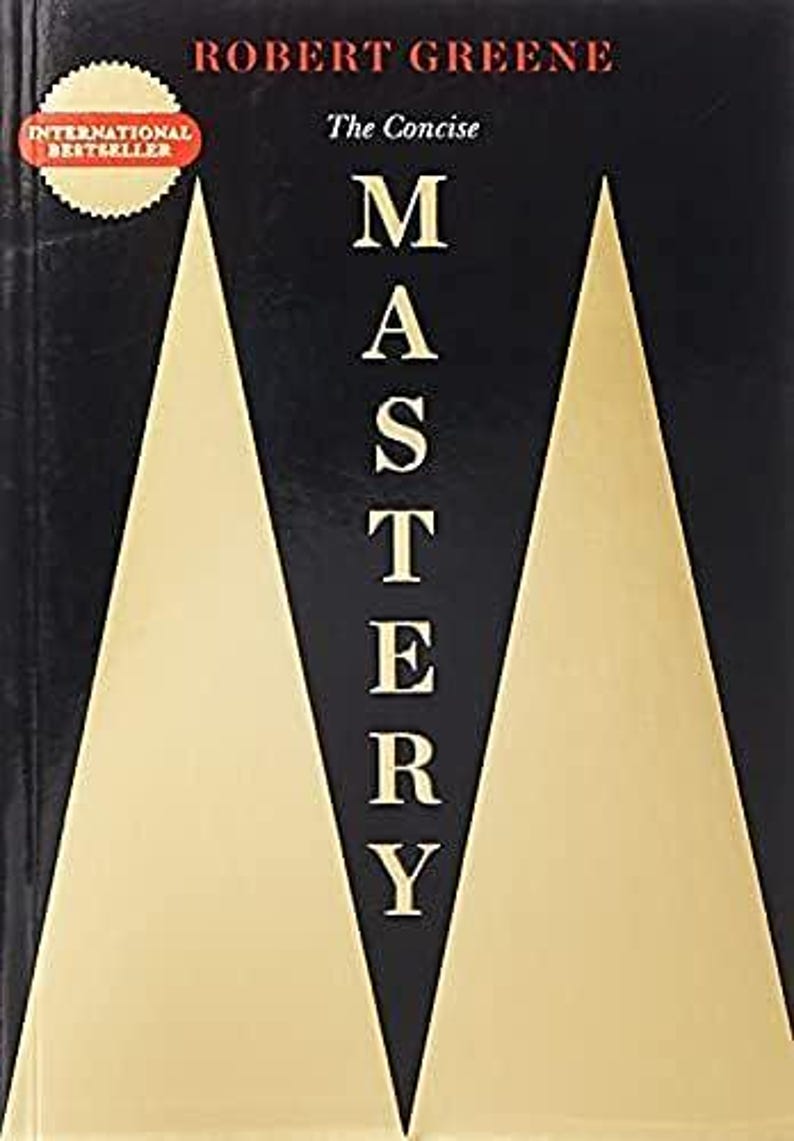 May include: The book cover for The Concise Mastery by Robert Greene features a black background with two large, gold-colored triangles pointing upward. The title Mastery is printed in white capital letters vertically between the gold shapes.