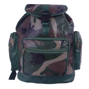 May include: A camouflage print backpack featuring a dark green leather base and trim. The bag includes a top flap with a black plastic buckle closure, a large front zippered pocket, and two side zippered pockets with metallic zipper pulls.