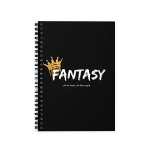 May include: Black spiral-bound notebook with the word "FANTASY" in white, a gold crown, and the text "win the Draft, win the League". The notebook is designed for fantasy sports enthusiasts.