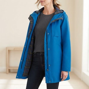 May include: A bright blue hooded raincoat featuring a front zipper closure with a snap-button placket. The interior is lined with a dark blue, green, and yellow plaid pattern. The jacket has long sleeves and a smooth, solid-colored exterior finish.